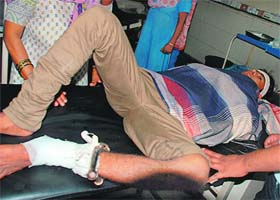 Vikram being treated at the Civil Hospital with his leg chained in Ambala on Wednesday