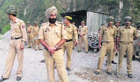 Policemen on duty at disputed land area in Gujjar Koti village in Talwara area of Reasi district on Wednesday