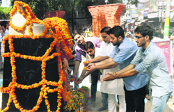 Students pay tributes to the student martyrs of 1966 agitation at Shaheedi Sthal, outside GGM Science College, in Jammu on Wednesday. Tribune photo: Anand Sharma