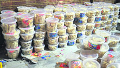 Packed barfi that was seized from a unit in the Salim Tabri area in Ludhiana; and (below) health officials inspect the raw material used in the preparation of sweets at the unit. 