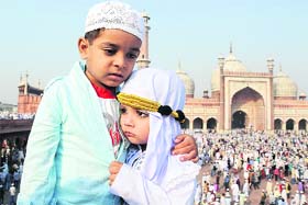 Children hug each other after offering Eid-ul-Zuha prayers at the Jama Masjid in New Delhi on Wednesday.