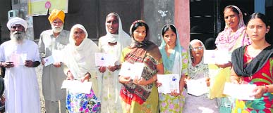Maqboolpura pensioners show the pension cards issued to them by the state government.