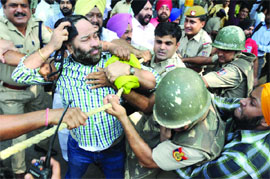 The police stop the workers of SAD (Badal) during a protest outside Chief Minister Sheila Dikshits residence in New Delhi on Thursday. 