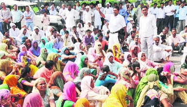 Residents of Lalupura village protest against land consolidation in front of the Mini-Secretariat in Karnal on Thursday. Tribune photo: Ravi Kumar