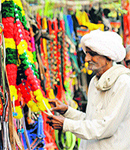 An elderly man selects items at a shop for his horses at a pony fair at Neval in Karnal
