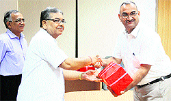 Prof Anand Mohan, Director, NIT (left), presents the wrist watches to Krishan GopaL, Librarian (right)