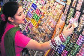 Festival time: A woman selects bangles ahead of Karva Chauth at Patel Bazaar in Jammu on Thursday