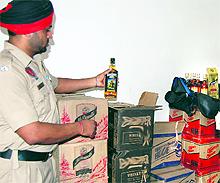 A policeman seizes 42 cases of illegally stocked liquor at Mohalla Gobindgarh in Jalandhar on Thursday