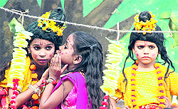Children dressed up as Lord Ram, Lakshman and Sita participate in