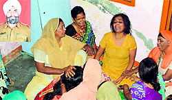 Relatives of the victim, Balbir Singh (inset), mourn his death in Ludhiana