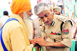 DGP Sumedh Singh Saini is all ears to a complainant at a function at Phul in Bathinda on Thursday.