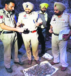Police officials examine the bullets recovered from historic Gobindgarh Fort in Amritsar on Friday