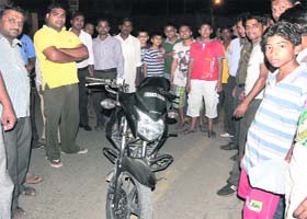 People gather outside a police station after catching two snatchers, along with the bike, on Amreek Singh road in Bathinda on Friday