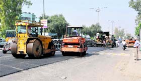Work in full swing: Road carpeting in progress near the Civil Hospital in Bathinda on Friday