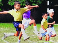 Students take part in a hurdle race during the annual sports day celebrations at The Tribune Model School, Sector 29, in Chandigarh on Friday. Tribune photo