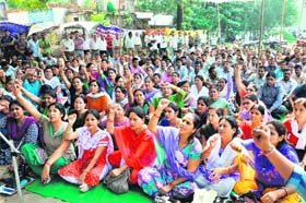 Striking state government employees hold a demonstration in support of their demands at the Parade Ground in Dehradun on Friday