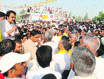 HJC supremo Kuldeep Bishnoi addresses people from his Vijay Rath at Pirthala village in Fatehabad on Friday. 