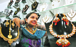 A woman tries artificial Jewellery ahead of Karva Chauth at Patel Bazaar in Jammu on Friday. Tribune Photo: Inderjeet Singh