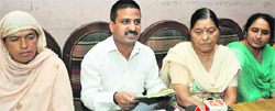 Members of the Jammu Women Credit Cooperative Ltd address mediapersons in Jammu on Friday. Tribune photo: Inderjeet Singh