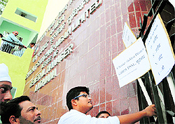Protesters lodge placards at the entrance to the BSNL office, Bharat Nagar, in Ludhiana on Friday