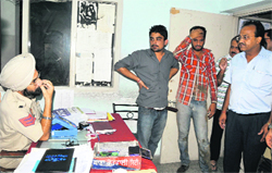 People gather at the police station after two snatchers were nabbed on Amrik Singh Road on Saturday evening. The police has been alerted to tackle criminal elements in view of the rush during the festive season.