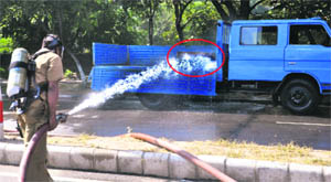 Firemen spray water on the leaked cylinder in Chandigarh on Saturday. 