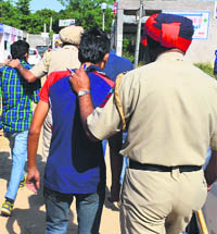 The police rounds up youths on a charge of black marketing at Phase IX of Mohali. 