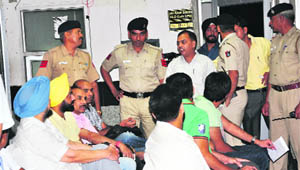 Police personnel oversee the auction. 