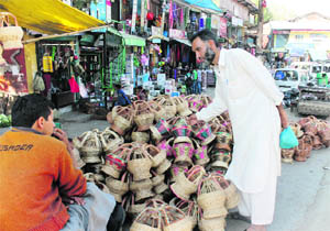 A roadside vendor sells Kangris, or traditional firepots, in Pulwama district on Saturday.