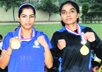 Shavinder Kaur and Parminder Kaur show their medals. A Tribune photograph 