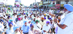 BKU president Balvir Singh Rajewal addresses farmers during a protest in Samrala on Saturday. A Tribune photograph 
