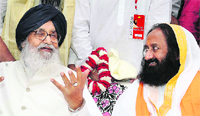 Chief Minister Parkash Singh Badal shares a point with Sri Sri Ravishankar at Anandpur Sahib on Saturday. A Tribune photo