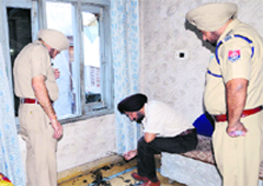 Police officials inspect the crime scene at Kot Harnam Dass in Amritsar on Saturday. Photo: Vishal Kumar