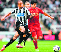 Newcastle's Loic Remy challenges Liverpool's Luis Suarez during their English Premier League match in Newcastle on Saturday. The match ended in a 2-2 draw.  AFP