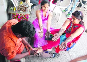 Festive fervour: Women get henna applied for the festival of Karva Chauth at Lawrance road in Amritsar on Sunday