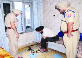 Officials examine the spot where the firing took place on Saturday
