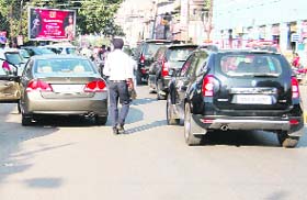Vehicles parked haphazardly on a roadside at Lawrence Road in Amritsar