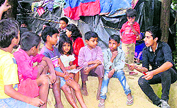 A MAD volunteer teaches slum children at Bihari Basti in Dehradun on Sunday