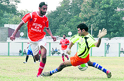 A match in progress during the 2nd Narendra Kharola Memorial Football Tournament at the pavillion ground in Dehradun on Sunday
