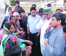 Saket Bahuguna directs the officials on phone to speed up the relief work during his visit to Parodi village in the Dhanaulti assembly segment near Mussoorie on Sunday. 