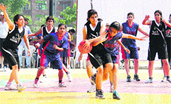Players of Thapar Engineering Institute, Patiala, and NIT, Kurukshetra (black), try to get hold of the ball during the AIU's North Zone Inter-University Basketball (Womens) Championship in Jalandhar on Sunday. Tribune Photo: Malkiat Singh