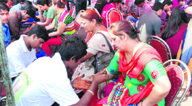 Artists apply henna on the hands of women on the eve of Karwa Chauth