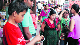  a child with a bowl of liquid used after applying henna at the Sector 7 market in Panchkula on Monday