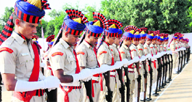 Policemen reverse their arms during a parade to mark Police Commemoration Day in Chandigarh on Monday.