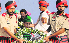 family members of a martyr pay homage during a function at Phase VIII in Mohali on Monday