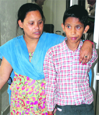 Vishal, who escaped from the clutches of the kidnappers, with his mother Renu at the Sector 14 police station in Panchkula on Monday.