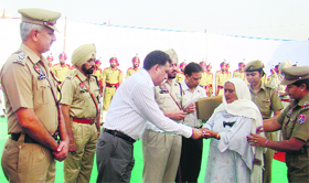 DC Arun Sekhri, SSP Gurmeet Singh Chauhan and other officials honour families of martyrs at a function in the Police Lines, Mahadian, on Monday.
