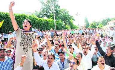 Striking state government em[ployees hold a protest in front of the Secretariat in support of their demands in Dehradun on Monday. Tribune photo: Vinod Pundir