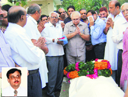 Agriculture Minister Paramvir Singh pays tributes to Panchkula Special CBI Magistrate Atul Marya (inset) before cremation at Tohana in Fatehabad on Monday.