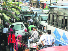 Commuters caught in a traffic jam in Kangra on Monday.